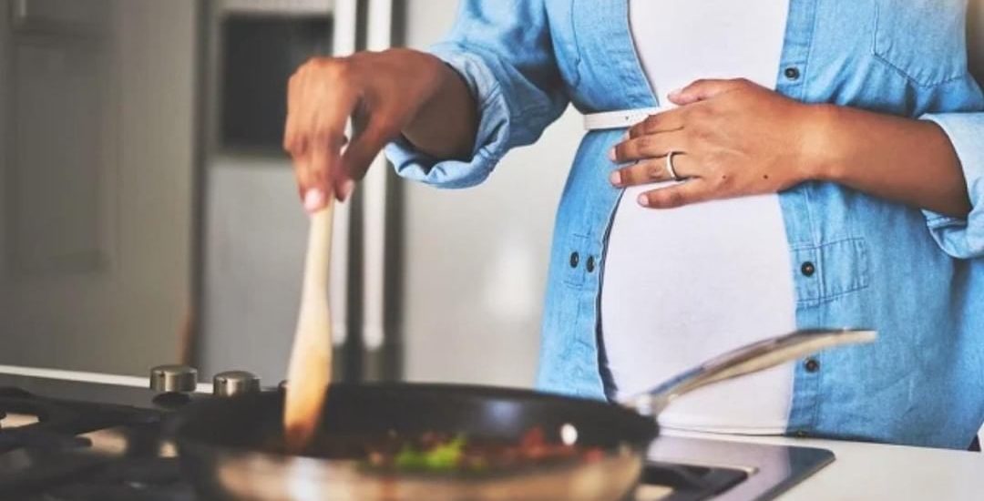 Pregnant person cooking