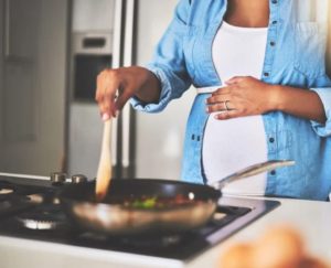 Pregnant person cooking 