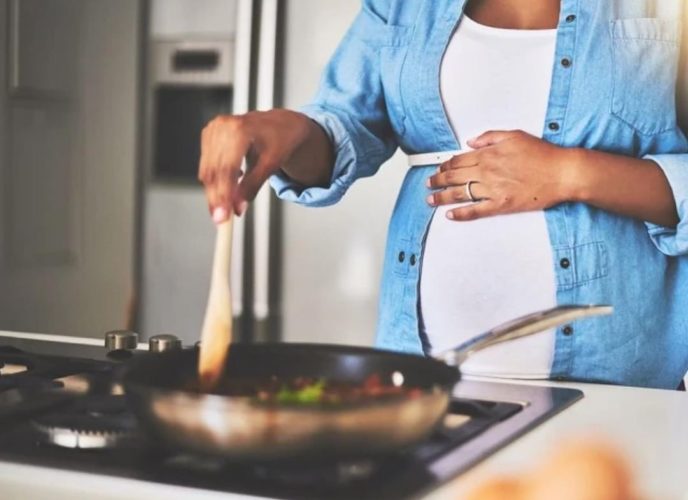 Pregnant person cooking