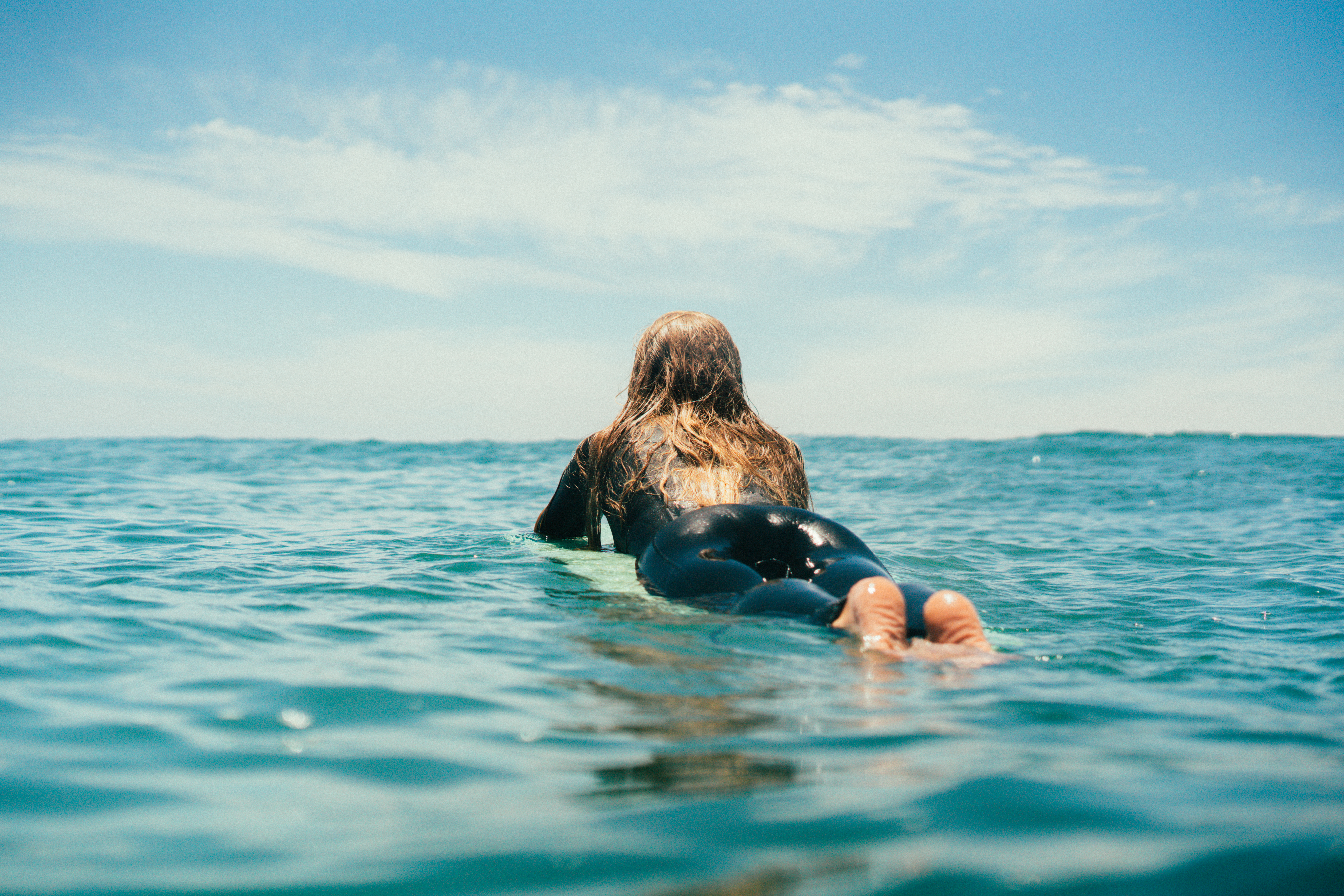 Girl surfing in the ocean